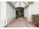 Inviting entryway with a decorative glass door and a cozy seating area on a brick walkway at 8782 Sw 82Nd Court Rd, Ocala, FL 34481