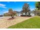 Single-story home with green lawn, circular driveway, mature landscaping, and attached garage at 8782 Sw 82Nd Court Rd, Ocala, FL 34481