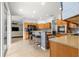 This spacious kitchen features tiled flooring, stainless steel appliances, a breakfast bar, and seamless flow to the living area at 8782 Sw 82Nd Court Rd, Ocala, FL 34481