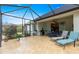 Screened-in patio featuring lounge chairs, table, tile flooring, and views of the backyard at 8782 Sw 82Nd Court Rd, Ocala, FL 34481