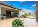 Covered patio with lounge chairs, outdoor dining, and a beautiful backyard view at 8782 Sw 82Nd Court Rd, Ocala, FL 34481