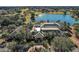 High angle view of the clubhouse with lake and golf course in the background at Spruce Creek Country Club at 9025 Se 136Th Loop, Summerfield, FL 34491