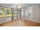 Sunroom with many windows allowing for natural light and views to the backyard at 9025 Se 136Th Loop, Summerfield, FL 34491