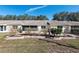 Neat backyard with shrubbery and retaining wall, leading to the back of the home with a screened in porch at 9504 Sw 97Th Ln # B, Ocala, FL 34481