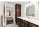 Bathroom with dark wood cabinets, white countertops, and view into the bedroom at 9504 Sw 97Th Ln # B, Ocala, FL 34481