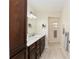 Bathroom featuring wood cabinets, white counters, and modern lighting at 9504 Sw 97Th Ln # B, Ocala, FL 34481