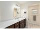 Bathroom featuring dark wood cabinets, white countertops, and modern lighting fixtures at 9504 Sw 97Th Ln # B, Ocala, FL 34481