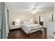 Bright bedroom with hardwood floors, ceiling fan, and modern white bedside tables and cabinets at 9504 Sw 97Th Ln # B, Ocala, FL 34481