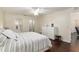 Bright bedroom with wood floors, ceiling fan, white furniture, and ensuite bathroom at 9504 Sw 97Th Ln # B, Ocala, FL 34481