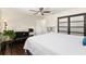 Bedroom featuring a ceiling fan, hardwood floors, and adjacent office space at 9504 Sw 97Th Ln # B, Ocala, FL 34481
