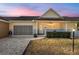 Charming home featuring a screened garage, inviting front porch, and well-maintained landscaping at 9504 Sw 97Th Ln # B, Ocala, FL 34481