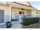 Inviting front porch with brick accents, ceiling fan, and manicured hedges at 9504 Sw 97Th Ln # B, Ocala, FL 34481