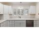 Bright kitchen with modern appliances, white cabinets, and a sink with a view at 9504 Sw 97Th Ln # B, Ocala, FL 34481