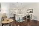Open concept kitchen featuring island with bar seating, stainless steel appliances and hardwood floors throughout at 9504 Sw 97Th Ln # B, Ocala, FL 34481