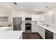 Bright kitchen featuring white cabinetry, stainless steel appliances, and wood flooring at 9504 Sw 97Th Ln # B, Ocala, FL 34481