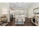 Bright kitchen features white cabinets, stainless steel appliances, and a center island with seating at 9504 Sw 97Th Ln # B, Ocala, FL 34481