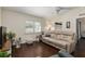 Inviting living room features wood floors, a ceiling fan, comfy sofa, and plantation shutters at 9504 Sw 97Th Ln # B, Ocala, FL 34481