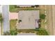 Overhead view of a home showing the roof shape, an enclosed patio, manicured landscaping, and a paved driveway at 9863 Sw 63Rd Loop, Ocala, FL 34481