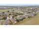 An aerial view shows the neighborhood's well-maintained homes, landscaping, and proximity to a golf course at 9863 Sw 63Rd Loop, Ocala, FL 34481