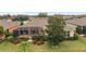 Aerial view of a home with a large screened lanai and manicured landscaping in a residential neighborhood at 9863 Sw 63Rd Loop, Ocala, FL 34481