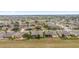 High aerial view showcasing homes in a quiet neighborhood near a golf course and a tranquil lake at 9863 Sw 63Rd Loop, Ocala, FL 34481
