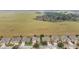 Aerial view of a residential neighborhood backing onto a large, open pasture with scattered trees and grazing animals at 9863 Sw 63Rd Loop, Ocala, FL 34481