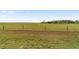 Expansive grassy backyard with a partially fenced perimeter, offering a serene and open space at 9863 Sw 63Rd Loop, Ocala, FL 34481
