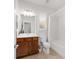 Bright bathroom with a wood vanity, a shower-tub combo, and neutral tile, providing a clean and functional space at 9863 Sw 63Rd Loop, Ocala, FL 34481