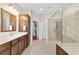 Bathroom featuring tile flooring, soaking tub, large shower, vanity, and linen storage at 9863 Sw 63Rd Loop, Ocala, FL 34481