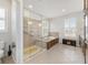 Bathroom with shower stall, soaking tub, tiled floors, and plantation shutters at 9863 Sw 63Rd Loop, Ocala, FL 34481