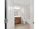 Well-lit bathroom featuring a wood vanity, a combined shower and tub, and neutral tile flooring at 9863 Sw 63Rd Loop, Ocala, FL 34481