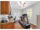 Bedroom features wood floors, a treadmill, built-in desk and natural light creating a functional workout and office area at 9863 Sw 63Rd Loop, Ocala, FL 34481