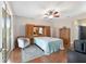 Primary bedroom with wooden floors, area rug, closet and sliding glass door with exterior views at 9863 Sw 63Rd Loop, Ocala, FL 34481