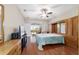 Primary bedroom with closet, TV, dresser, and sliding glass doors with exterior views at 9863 Sw 63Rd Loop, Ocala, FL 34481