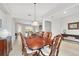 Well-lit dining room with a wooden table, tile floors, view to the living room and access to other areas at 9863 Sw 63Rd Loop, Ocala, FL 34481