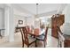 Well-lit dining room with a wooden table, tile floors, a view of the window, and access to other living areas at 9863 Sw 63Rd Loop, Ocala, FL 34481