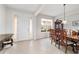 Elegant dining room featuring tile floors, a stylish chandelier, and an exterior door for ample natural light at 9863 Sw 63Rd Loop, Ocala, FL 34481