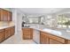 This kitchen features tile floors, light countertops, stainless appliances, and a view to the living room at 9863 Sw 63Rd Loop, Ocala, FL 34481