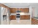 Updated kitchen features stainless appliances, tile floors, and dark wooden cabinetry at 9863 Sw 63Rd Loop, Ocala, FL 34481