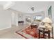 Spacious living room featuring tile floors, a stylish rug, comfortable seating and access to the screened-in porch at 9863 Sw 63Rd Loop, Ocala, FL 34481