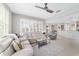 Bright, open living room with large windows and comfortable seating and an open concept kitchen at 9863 Sw 63Rd Loop, Ocala, FL 34481
