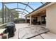 Large screened patio with outdoor cooking area overlooks the big private and fenced back yard at 9863 Sw 63Rd Loop, Ocala, FL 34481