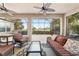 Relaxing screened patio with ceiling fans and comfortable furniture overlooking a large fenced back yard at 9863 Sw 63Rd Loop, Ocala, FL 34481