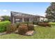 A lovely backyard with beautiful landscaping and a screened-in porch perfect for outdoor living at 9863 Sw 63Rd Loop, Ocala, FL 34481