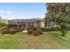 A beautiful backyard featuring a large screened lanai, mature trees, and well maintained landscape at 9863 Sw 63Rd Loop, Ocala, FL 34481