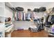 Spacious walk-in closet with wood floor, multiple shelves and racks providing ample storage solutions at 9863 Sw 63Rd Loop, Ocala, FL 34481