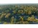 This aerial view shows the property situated among dense trees in a peaceful neighborhood at 4040 E Fort King St, Ocala, FL 34470