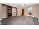 Bedroom featuring wood-look floors, built-in closet, and bathroom access at 4040 E Fort King St, Ocala, FL 34470