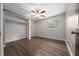 Well-lit bedroom featuring wood floors, a ceiling fan, and a closet with shelving at 4040 E Fort King St, Ocala, FL 34470