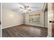 Cozy bedroom with a ceiling fan, built-in shelves, and a window view of the outdoors at 4040 E Fort King St, Ocala, FL 34470